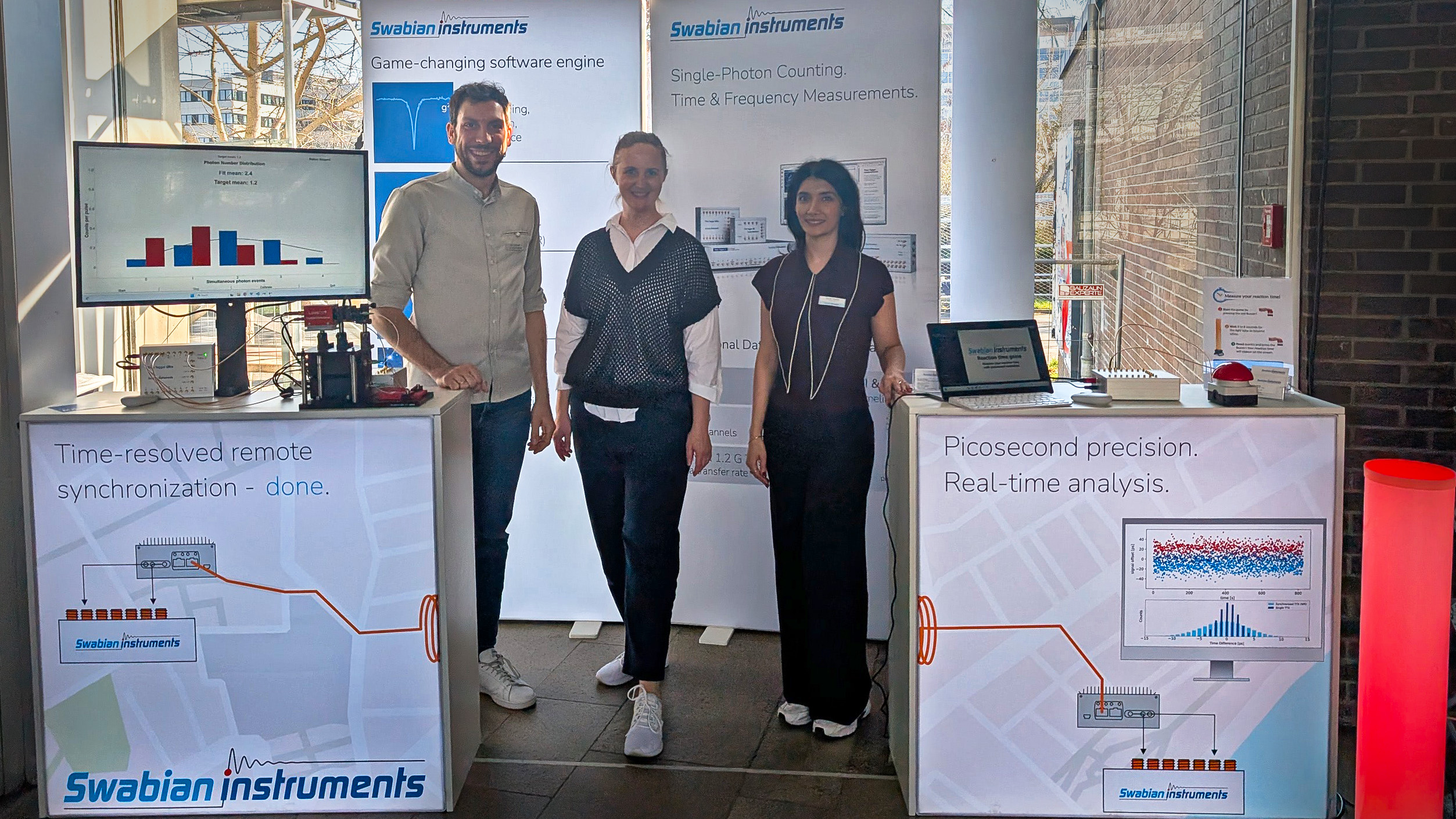 Swabian Instruments team members at their booth during DPG SAMOP 2026 in Mainz, presenting photon counting and timing solutions to conference visitors. From left to right: Timon Eichhorn, Yulia Matiks, Zeynab Tavakoli.